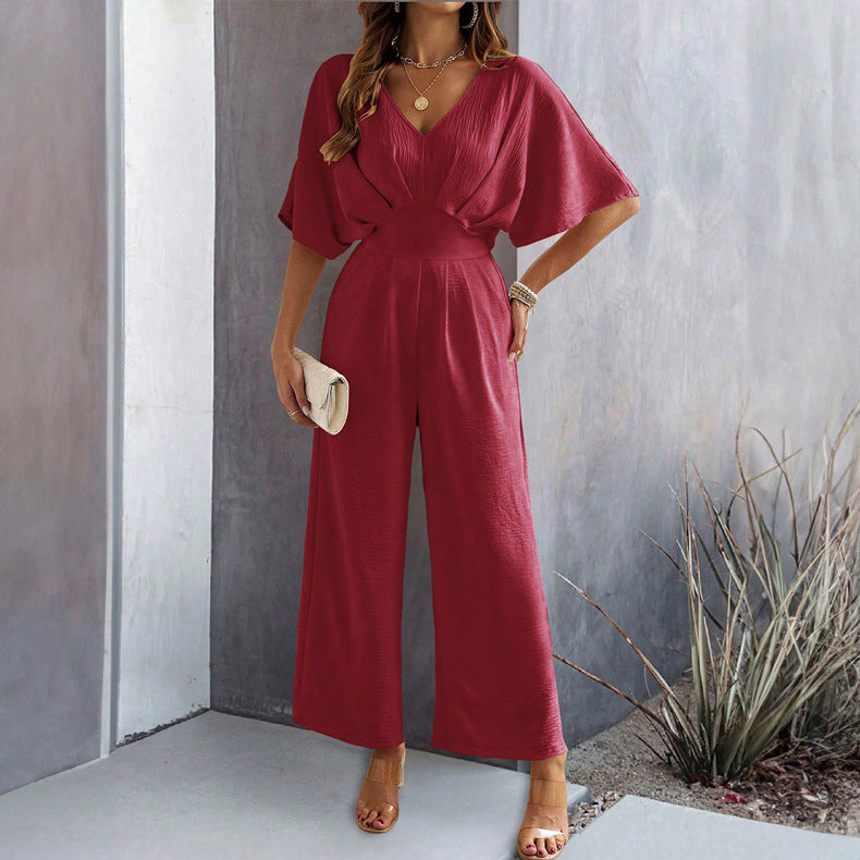 Dame Vid Jumpsuit med Elegant Drapering og V-hals