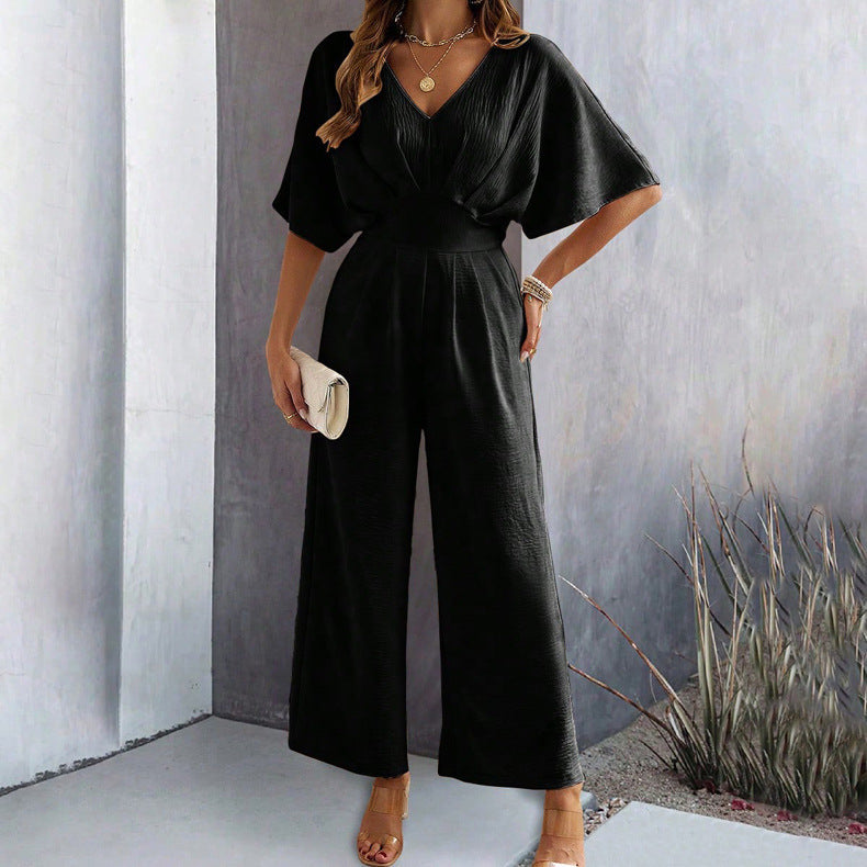 Dame Vid Jumpsuit med Elegant Drapering og V-hals